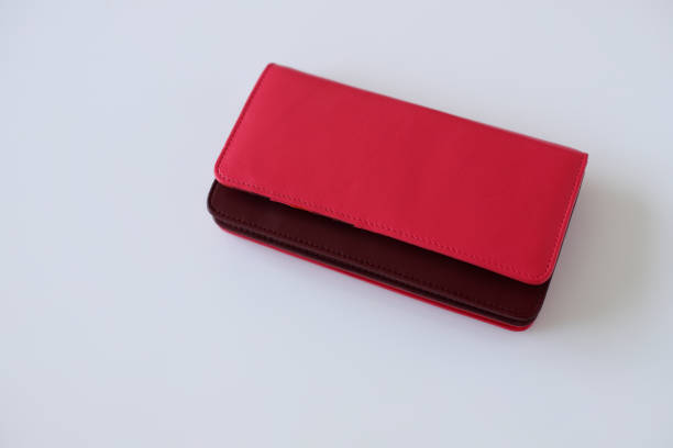 istock Red leather female wallet on white background, stylish accessory 1553082347
