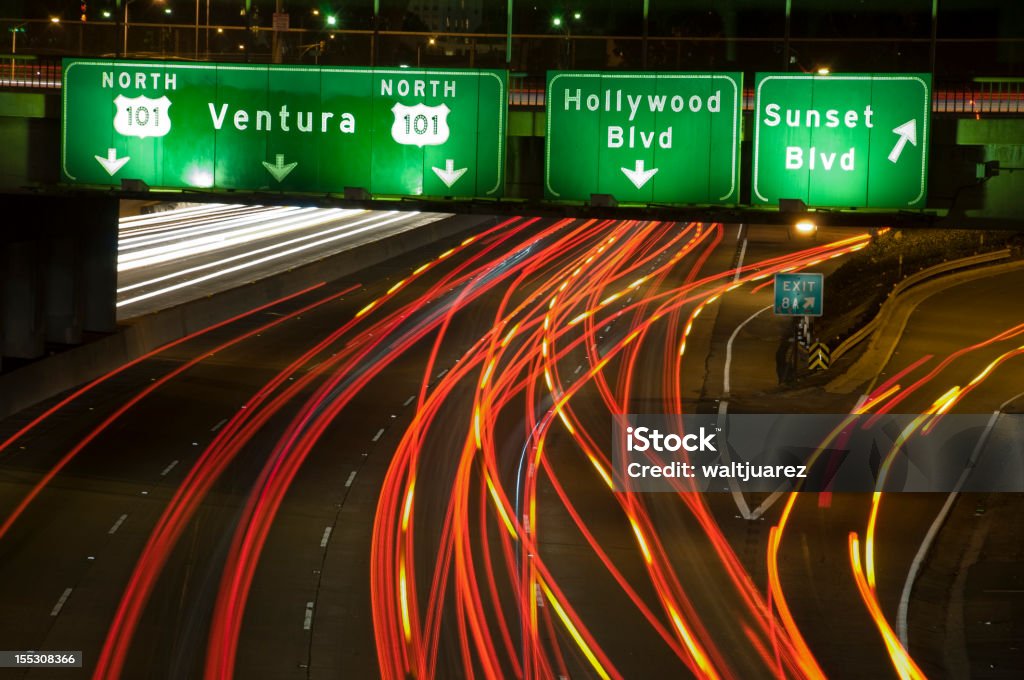 The 101 Freeway Sunset Exit 101 North freeway in Los angeles, California. Sunset blvd exit. Car headlights long exposure.   Exit Sign Stock Photo