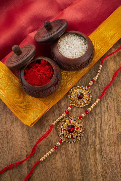 istock Raksha Bandhan background with Rakhi string, Rice Grains and Kumkum 1553085008