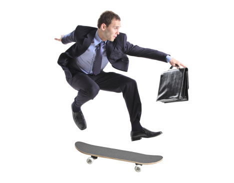 A businessman with skateboard jumping isolated on a white background