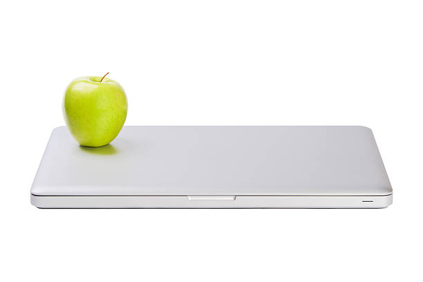 Modern slim laptop with green apple stock photo