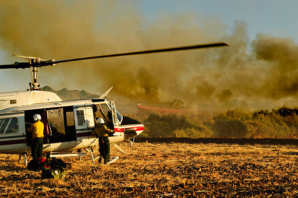 Penrith, Australia - October 23, 2013:  NSW Rural Fire Service Erickson Air-Crane fills with water to fight ongoing out of control bush fires in the Blue Mountains.  Heavy smoke fills the air.  The air-crane can suck up 9000 litres of water through its snorkel in under a minute.
