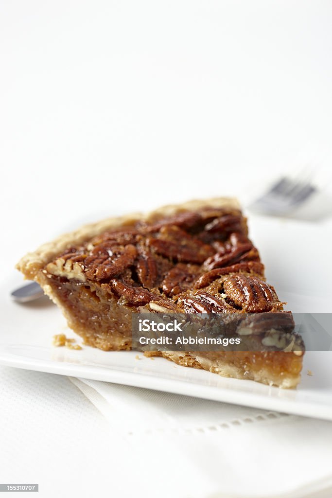 Pecan Pie Slice of homemade pecan pie in a white setting. Pecan Pie Stock Photo