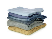 Pile of folded clothes on a white background