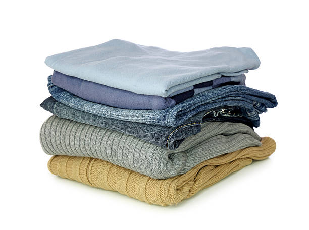 Pile of folded clothes on a white background Stack of clothes isolated on white background coat garment photos stock pictures, royalty-free photos & images