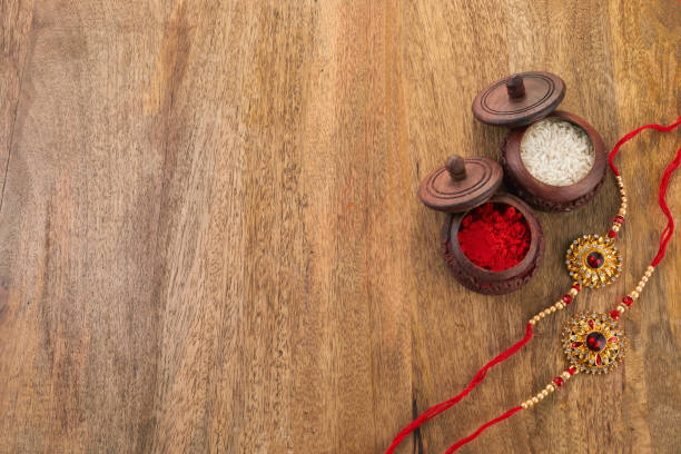 istock Raksha Bandhan background with Rakhi string, Rice Grains and Kumkum 1553110489