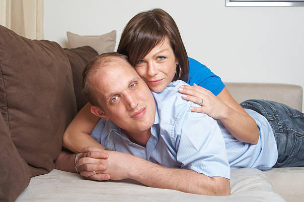 Lovers on the couch stock photo