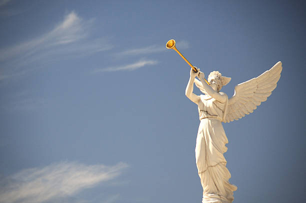 Angel blowing a horn stock photo