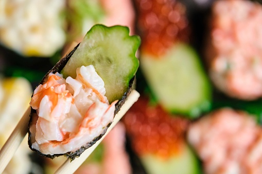 Ikura gunkan with cucumber and prawn. Japanese sushi.