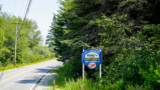 Stonington, Maine, USA - July 13, 2023: Stonington road sign in summer landscape near road