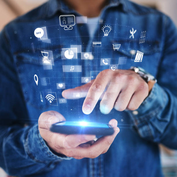 istock Phone in hand, hologram and overlay with futuristic icons, data safety or software developer with mobile app, technology and innovation. Ux, cyber security or digital transformation on smartphone 1553142700