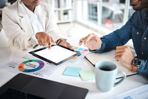 istock Mockup tablet screen, teamwork and hands of business people communication, analysis and working on trend research. Research, partnership and creative advertising team cooperation on strategy planning 1553144272