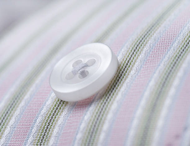 button on pinstripe shirt macro stock photo