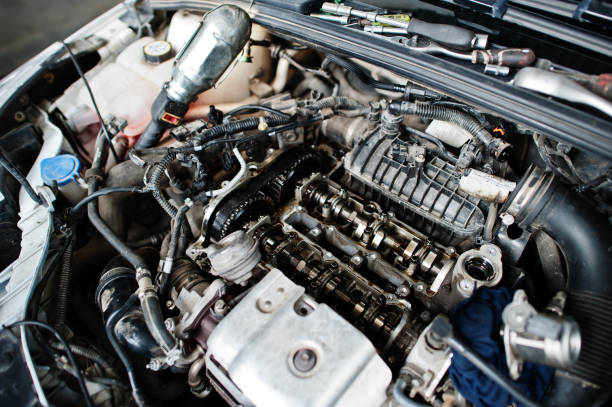 istock Car repair and maintenance theme. Open hood engine in auto service. 1553163236