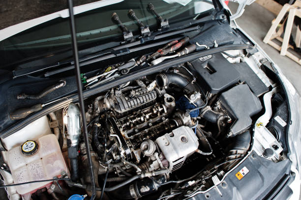 istock Car repair and maintenance theme. Open hood engine in auto service. 1553164933