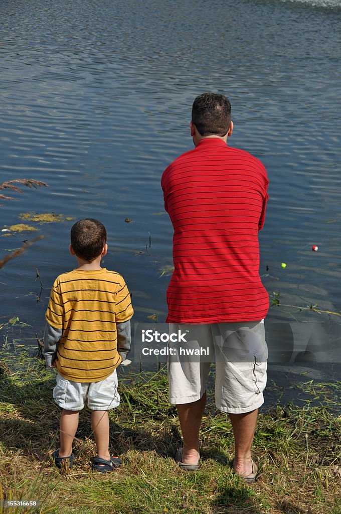 teach a boy to fish a father spends the day teaching his son to fish Adult Stock Photo
