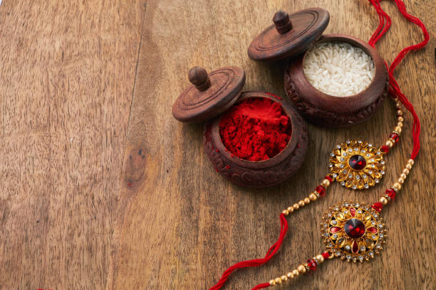 istock Raksha Bandhan background with Rakhi string, Rice Grains and Kumkum 1553170293