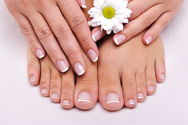 Skincare of a beauty female feet Skincare of a beauty female feet with camomile's flower toenail stock pictures, royalty-free photos & images