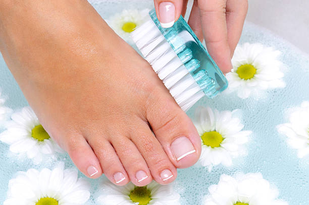 istock female washes and cleans the toenails 155317107