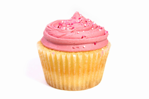 Creamy pink cupcake isolated on a white background