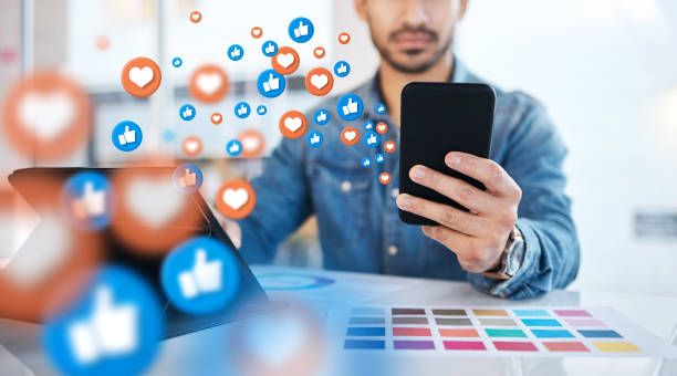istock Notification, phone and businessman on social media networking as communication with overlay or graphic like. Digital, heart emoji and employee or worker texting on a mobile app, website or web 1553178763