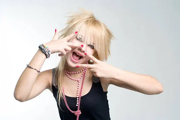 Grimacing blond punk girl posing mouth open