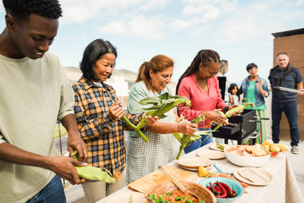 istock Multigenerational people doing barbecue at home's rooftop - Multiracial friends having fun eating and cooking together during weekend day - Summer and food concept - Main focus on asian woman face 1553185771