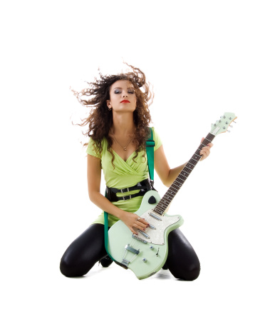 Cute women with electric guitar. Studio isolated