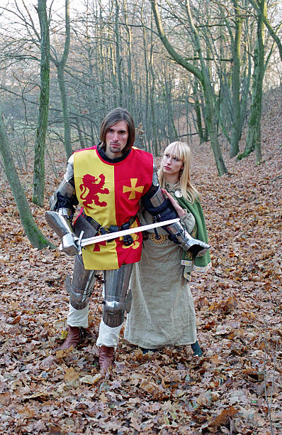 istock brave knight and maid walking in forest 155319339