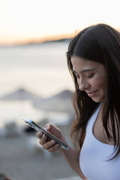 istock Young woman is texting a message on mobile phone. 1553193409