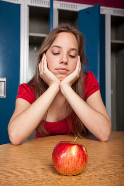 Teenage student contemplating lunch stock photo