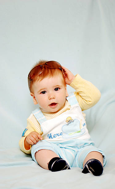 istock baby boy on blue smiling 155320204