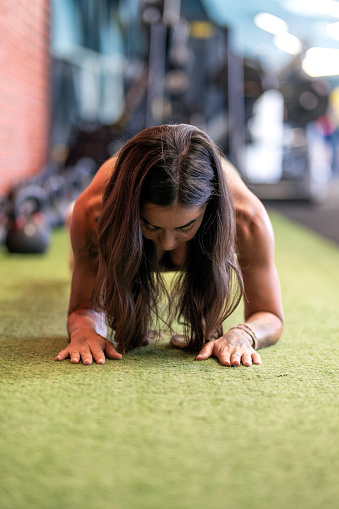Muscular woman doing plank exercise