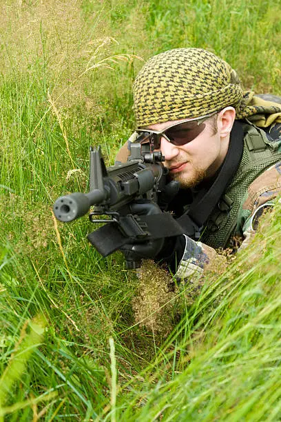 Photo of Sniper laying in a grass