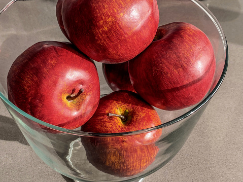 High angle view of fake plastic apples used for decoration inside glass jar