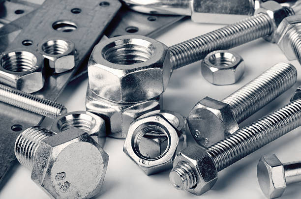 Fasteners Close-up of various steel nuts and bolts nut fastener stock pictures, royalty-free photos & images