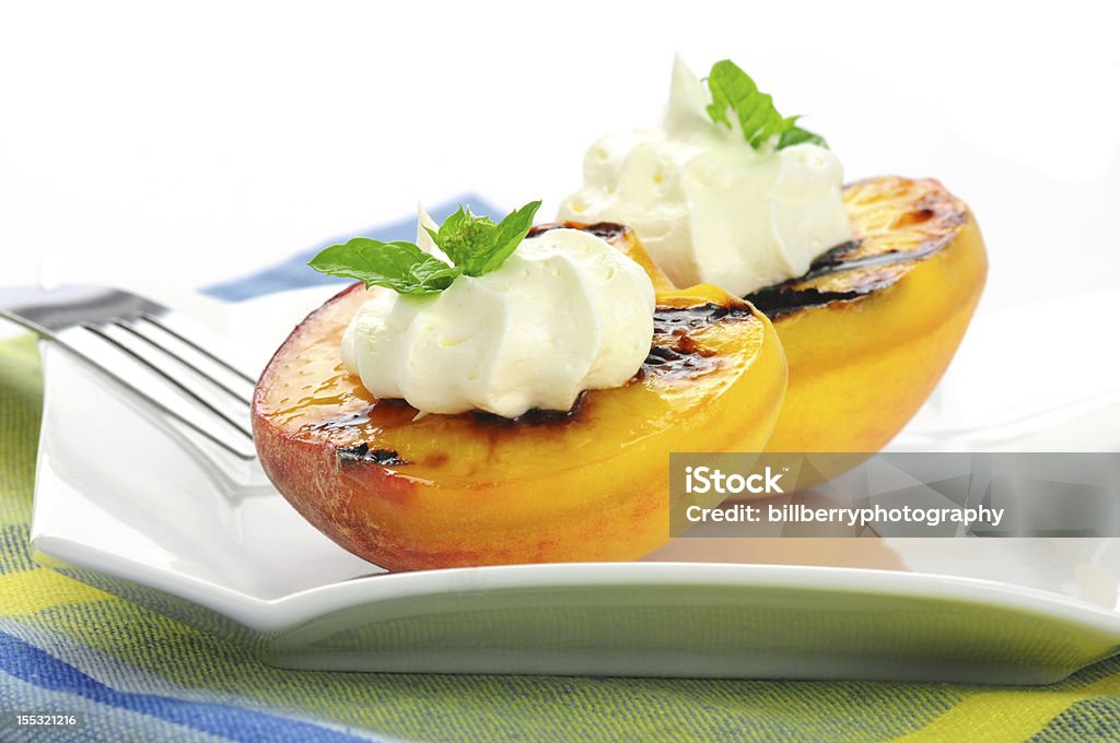 Grilled Peaches Delicious grilled peaches and whipped cream. Peach Stock Photo