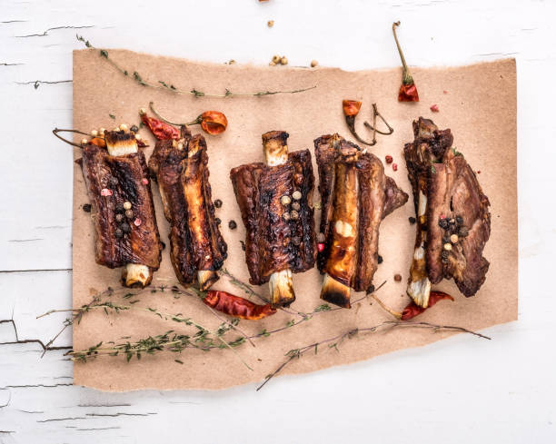 istock Grilled pork ribs with herbs top view 1553225278