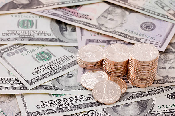 istock US Dollar Bills with Gold Coins 155322847