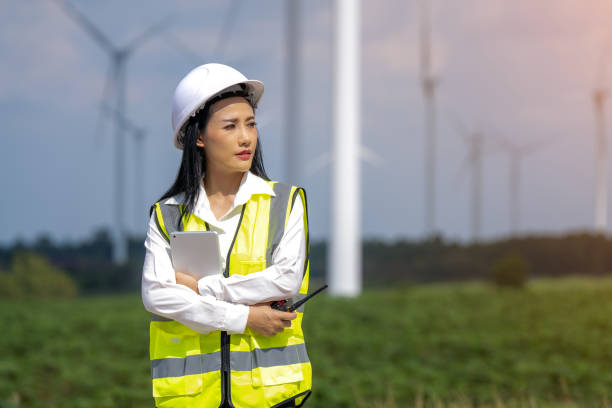 istock Female engineer planning on wind turbine maintenance work, nature renewable energy concept, wind power 1553230658