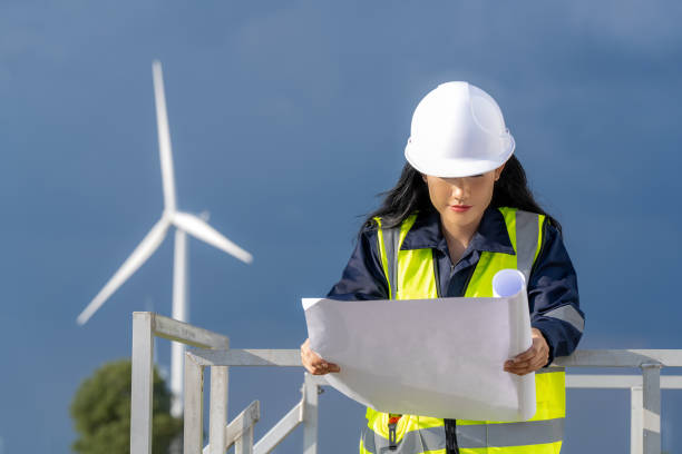 istock Female engineer planning on wind turbine maintenance work, nature renewable energy concept, wind power 1553231204