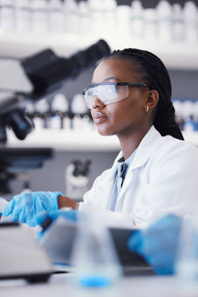 istock African scientist woman, laboratory and microscope analysis with thinking, pharmaceutical company or virus. Lady, medical research and brainstorming with data, info and pharma study for healthcare 1553232870