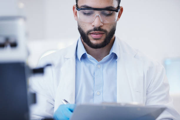 istock Results, man or scientist writing research notes for analysis on experiment, information or innovation. Biologist, biotechnology or researcher in a laboratory with documents for science development 1553232893