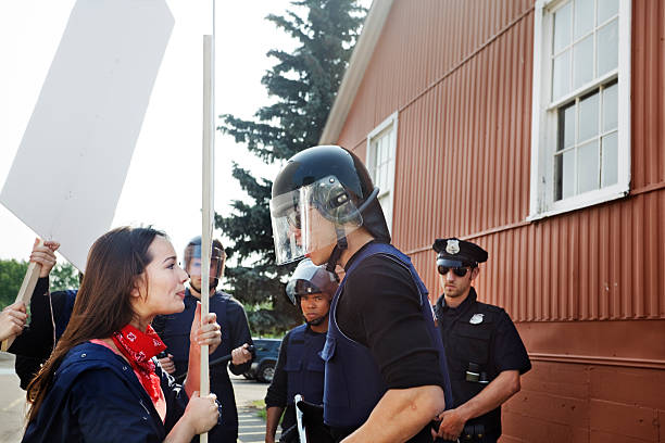 Protester tries to interrupt officer stock photo