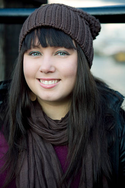 istock portrait young smiling woman in hat 155323428
