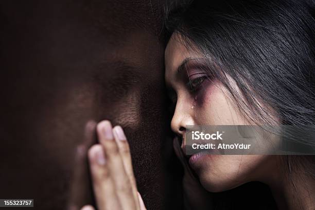 Injured Woman Leaning Sadly On Wooden Wall Stock Photo - Download Image Now - Domestic Violence, Human Face, Violence