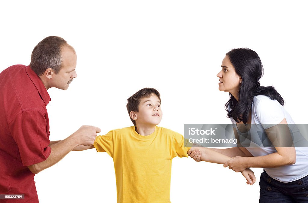 A married couple having a domestic conflict Hands of parents fighting over their son each pulling him their way. Child Stock Photo