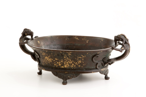 Antique Chinese cast-iron bowl with two dragon handles and gold flakes in enamel.