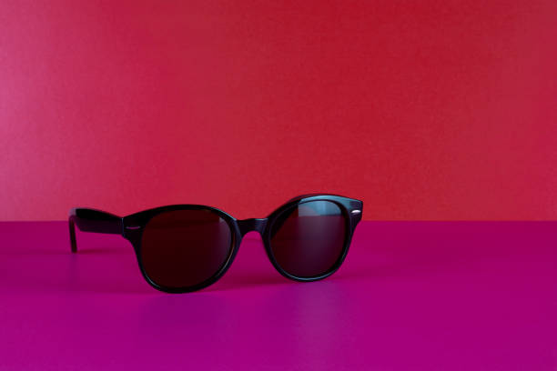 istock Designer Sunglasses on a Pink Surface with Red Background 1553253426