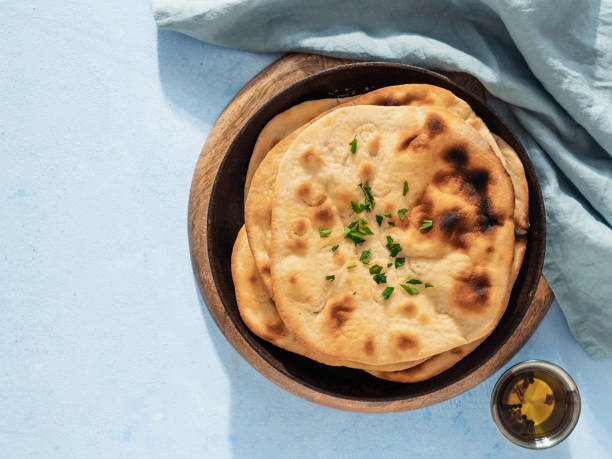 istock naan flatbread on blue, copy space, top view 1553258815